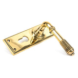 This is an image showing From The Anvil - Aged Brass Reeded Lever Euro Lock Set available from trade door handles, quick delivery and discounted prices