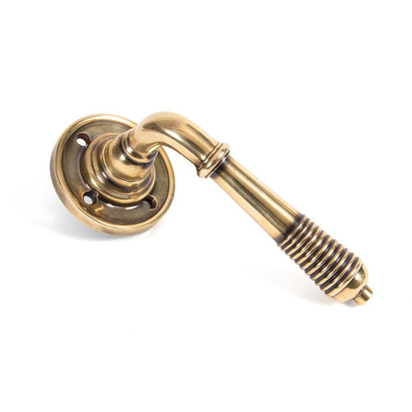 This is an image of From The Anvil - Aged Brass Reeded Lever on Rose Set available to order from T.H Wiggans Architectural Ironmongery in Kendal, quick delivery and discounted prices.