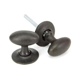 This is an image showing From The Anvil - Beeswax Oval Mortice/Rim Knob Set available from trade door handles, quick delivery and discounted prices