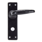 This is an image showing From The Anvil - Black Smooth Lever Bathroom Set available from trade door handles, quick delivery and discounted prices