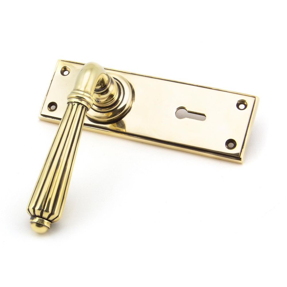 This is an image showing From The Anvil - Aged Brass Hinton Lever Lock Set available from trade door handles, quick delivery and discounted prices