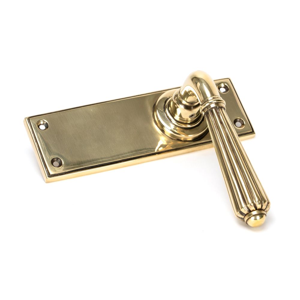 This is an image showing From The Anvil - Aged Brass Hinton Lever Latch Set available from trade door handles, quick delivery and discounted prices