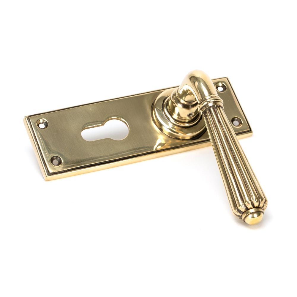 This is an image showing From The Anvil - Aged Brass Hinton Lever Euro Lock Set available from trade door handles, quick delivery and discounted prices