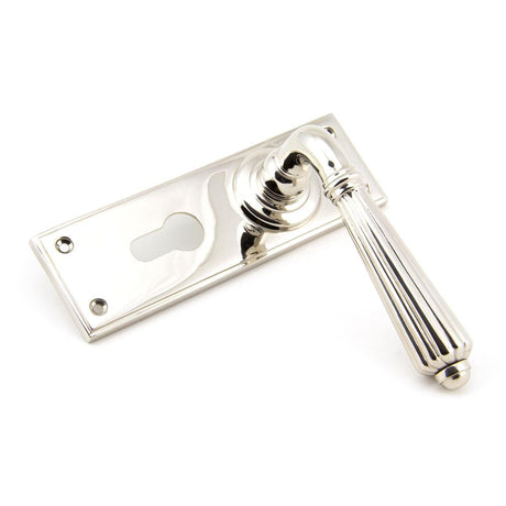 This is an image showing From The Anvil - Polished Nickel Hinton Lever Euro Lock Set available from trade door handles, quick delivery and discounted prices