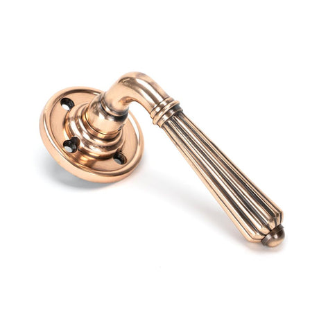 This is an image of From The Anvil - Polished Bronze Hinton Lever on Rose Set available to order from T.H Wiggans Architectural Ironmongery in Kendal, quick delivery and discounted prices.