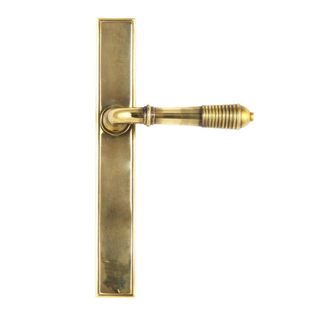 This is an image showing From The Anvil - Aged Brass Reeded Slimline Lever Latch Set available from trade door handles, quick delivery and discounted prices