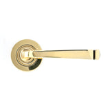 This is an image showing From The Anvil - Aged Brass Avon Round Lever on Rose Set (Plain) available from trade door handles, quick delivery and discounted prices