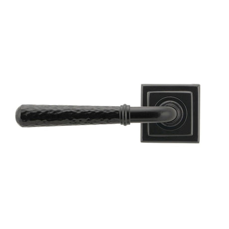 This is an image showing From The Anvil - Black Hammered Newbury Lever on Rose Set (Square) available from trade door handles, quick delivery and discounted prices