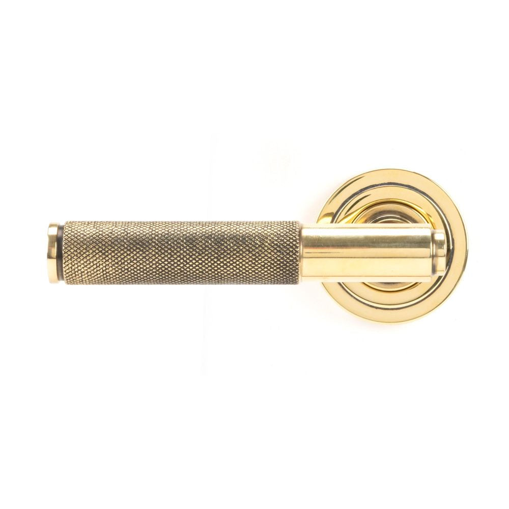 This is an image showing From The Anvil - Aged Brass Brompton Lever on Rose Set (Art Deco) available from trade door handles, quick delivery and discounted prices