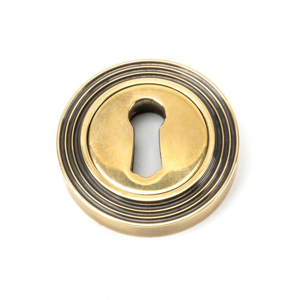 This is an image of From The Anvil - Aged Brass Round Escutcheon (Beehive) available to order from T.H Wiggans Architectural Ironmongery in Kendal, quick delivery and discounted prices.