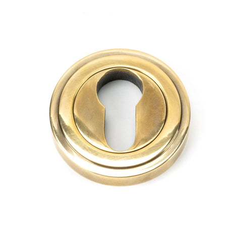 This is an image of From The Anvil - Aged Brass Round Euro Escutcheon (Art Deco) available to order from T.H Wiggans Architectural Ironmongery in Kendal, quick delivery and discounted prices.