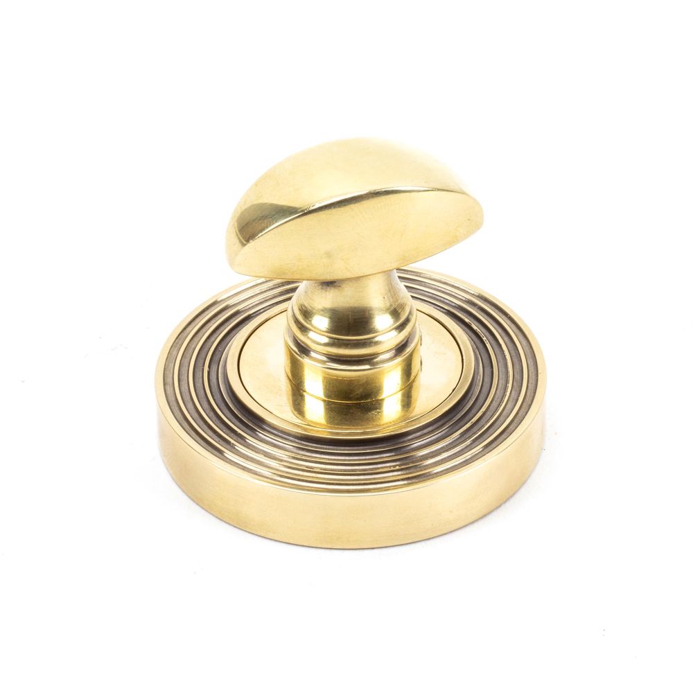 This is an image showing From The Anvil - Aged Brass Round Thumbturn Set (Beehive) available from trade door handles, quick delivery and discounted prices