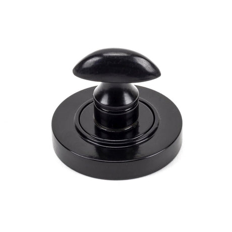 This is an image showing From The Anvil - Black Round Thumbturn Set (Plain) available from trade door handles, quick delivery and discounted prices