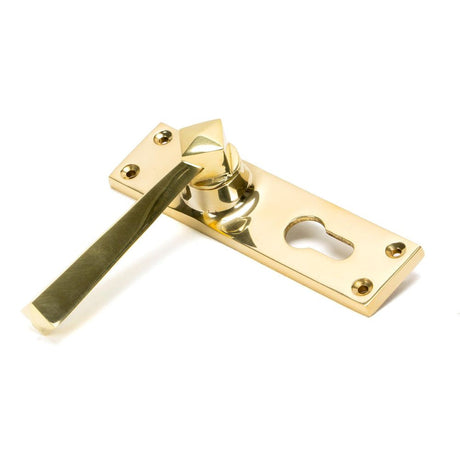 This is an image showing From The Anvil - Polished Brass Straight Lever Euro Lock Set available from trade door handles, quick delivery and discounted prices