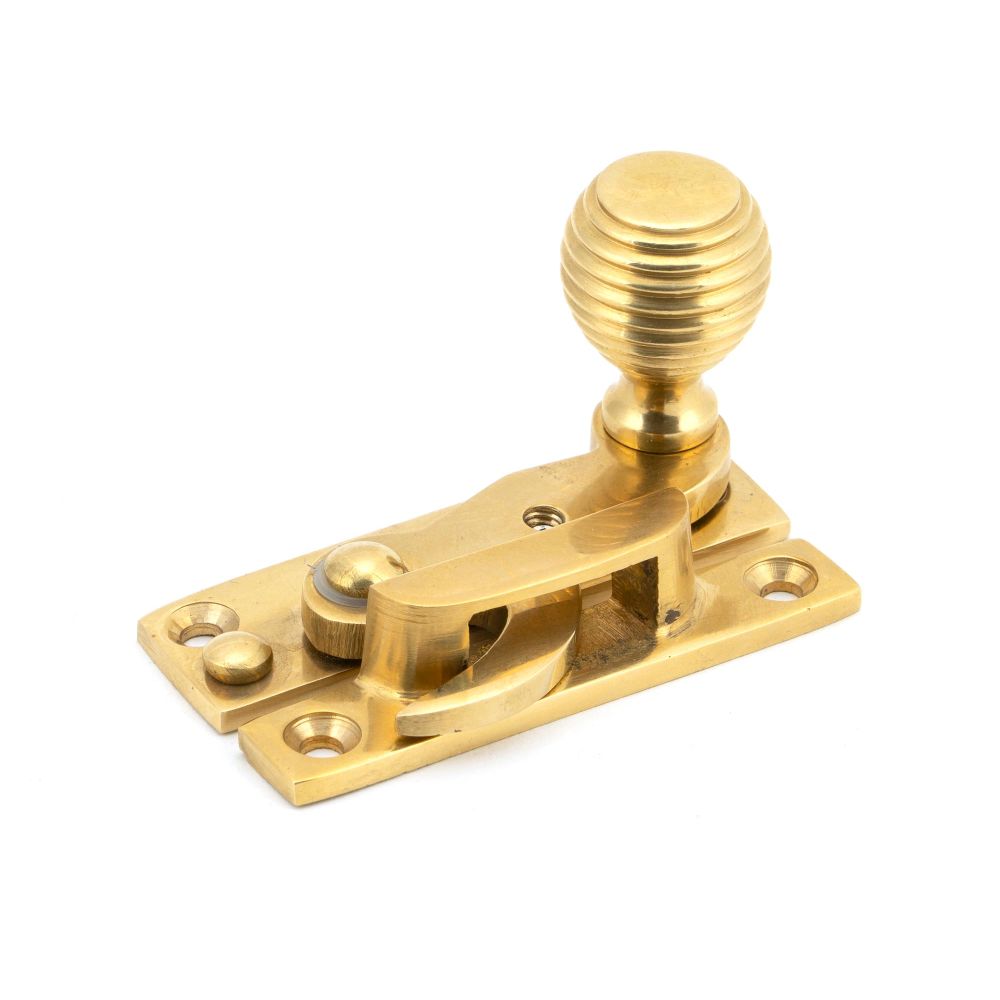 This is an image showing From The Anvil - Polished Brass Beehive Sash Hook Fastener available from T.H Wiggans Architectural Ironmongery in Kendal, quick delivery and discounted prices