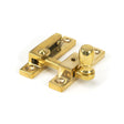 This is an image showing From The Anvil - Polished Brass Mushroom Quadrant Fastener - Narrow available from T.H Wiggans Architectural Ironmongery in Kendal, quick delivery and discounted prices