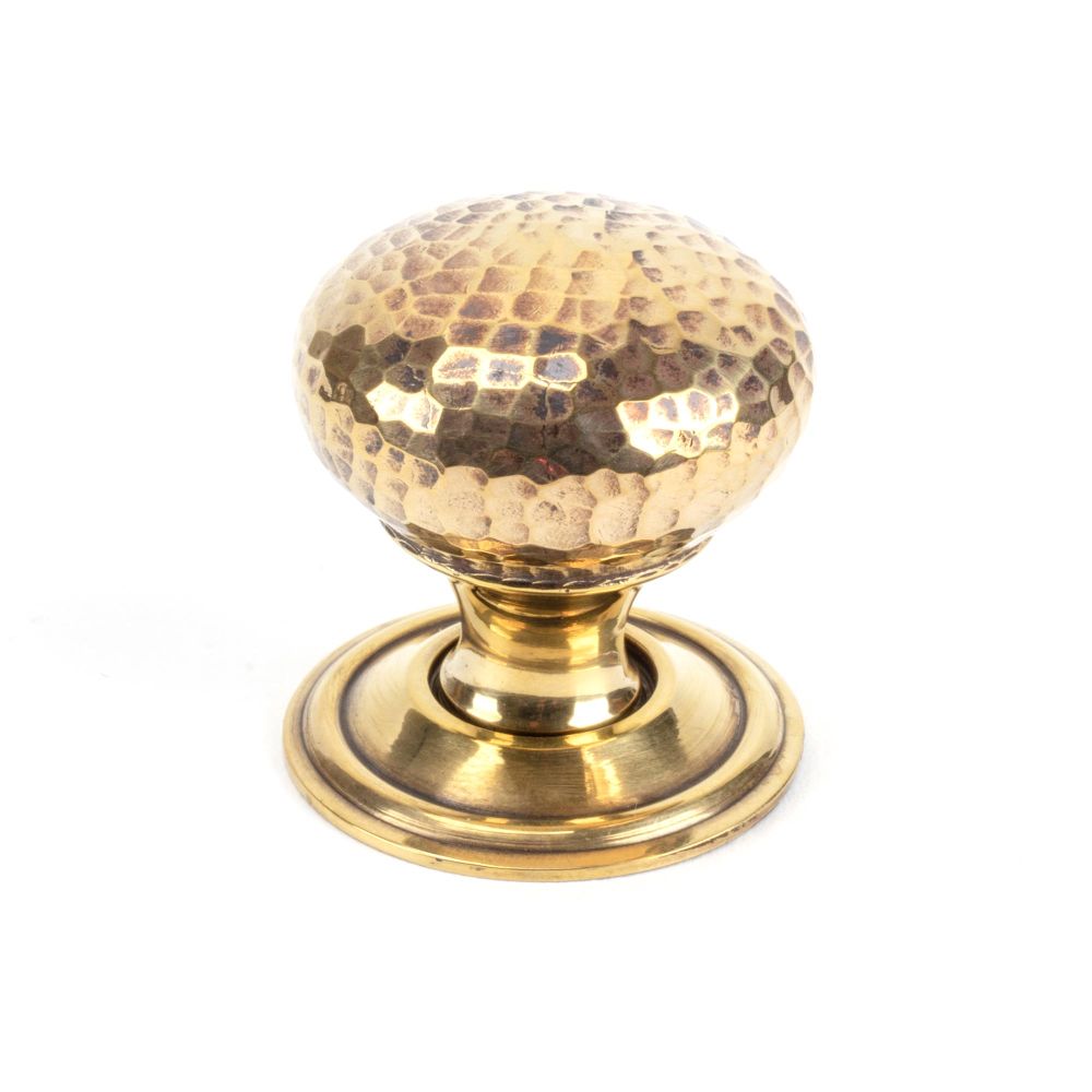 This is an image showing From The Anvil - Aged Brass Hammered Mushroom Cabinet Knob 32mm available from T.H Wiggans Architectural Ironmongery in Kendal, quick delivery and discounted prices