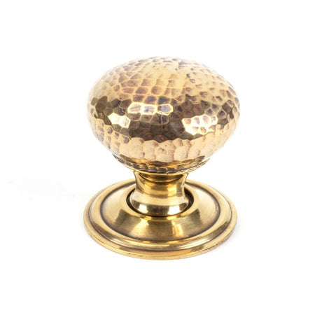 This is an image showing From The Anvil - Aged Brass Hammered Mushroom Cabinet Knob 32mm available from T.H Wiggans Architectural Ironmongery in Kendal, quick delivery and discounted prices