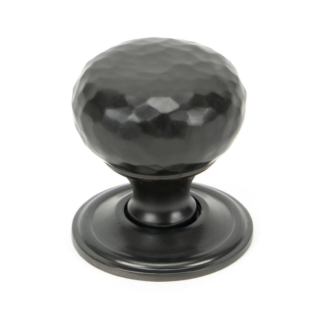 This is an image showing From The Anvil - Aged Bronze Hammered Mushroom Cabinet Knob 32mm available from T.H Wiggans Architectural Ironmongery in Kendal, quick delivery and discounted prices