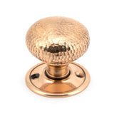 This is an image showing From The Anvil - Polished Bronze Hammered Mushroom Mortice/Rim Knob Set available from trade door handles, quick delivery and discounted prices