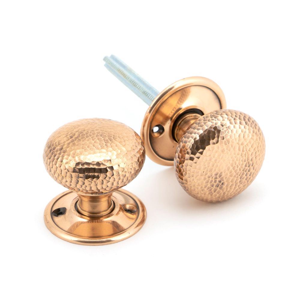 This is an image of From The Anvil - Polished Bronze Hammered Mushroom Mortice/Rim Knob Set available to order from T.H Wiggans Architectural Ironmongery in Kendal, quick delivery and discounted prices.