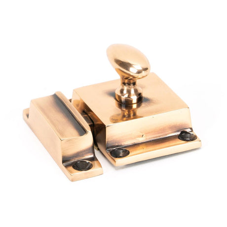 This is an image showing From The Anvil - Polished Bronze Cabinet Latch available from T.H Wiggans Architectural Ironmongery in Kendal, quick delivery and discounted prices
