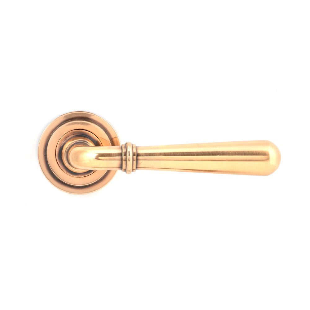 This is an image showing From The Anvil - Polished Bronze Newbury Lever on Rose Set (Art Deco) available from trade door handles, quick delivery and discounted prices