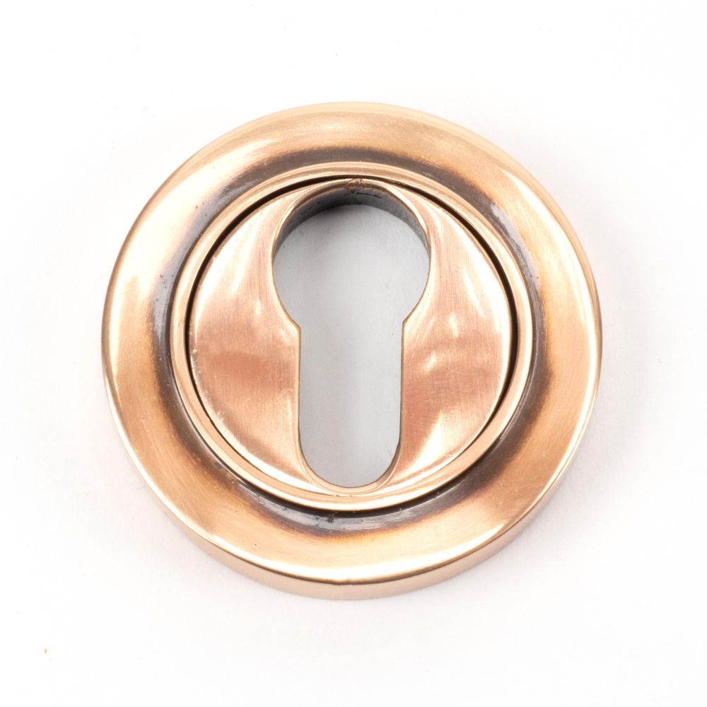 This is an image of From The Anvil - Polished Bronze Round Euro Escutcheon (Plain) available to order from T.H Wiggans Architectural Ironmongery in Kendal, quick delivery and discounted prices.