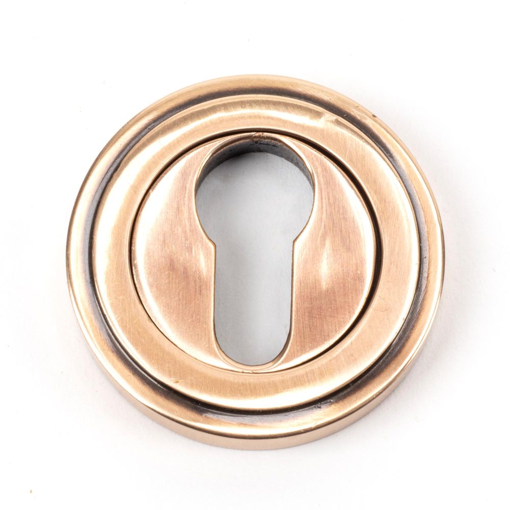 This is an image of From The Anvil - Polished Bronze Round Euro Escutcheon (Art Deco) available to order from T.H Wiggans Architectural Ironmongery in Kendal, quick delivery and discounted prices.