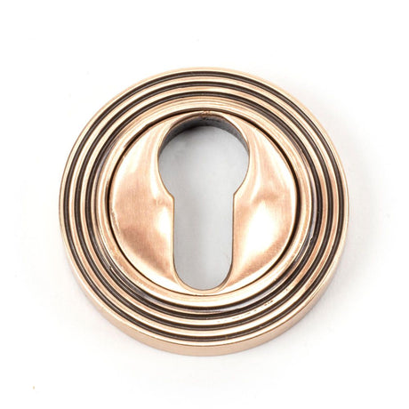 This is an image of From The Anvil - Polished Bronze Round Euro Escutcheon (Beehive) available to order from T.H Wiggans Architectural Ironmongery in Kendal, quick delivery and discounted prices.