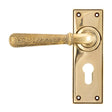 This is an image of From The Anvil - Aged Brass Hammered Newbury Lever Euro Lock Set available to order from T.H Wiggans Architectural Ironmongery in Kendal, quick delivery and discounted prices.