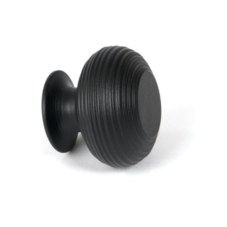 This is an image showing From The Anvil - Matt Black Beehive Cabinet Knob 40mm available from trade door handles, quick delivery and discounted prices