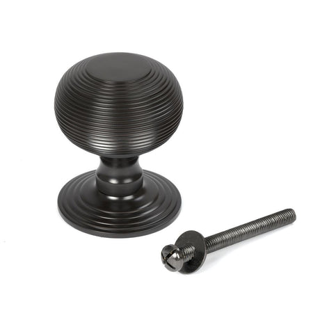 This is an image showing From The Anvil - Aged Bronze Beehive Centre Door Knob available from trade door handles, quick delivery and discounted prices