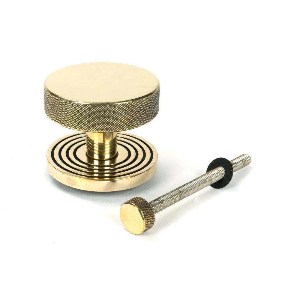 This is an image showing From The Anvil - Aged Brass Brompton Centre Door Knob (Beehive) available from trade door handles, quick delivery and discounted prices