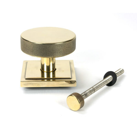 This is an image showing From The Anvil - Aged Brass Brompton Centre Door Knob (Square) available from trade door handles, quick delivery and discounted prices