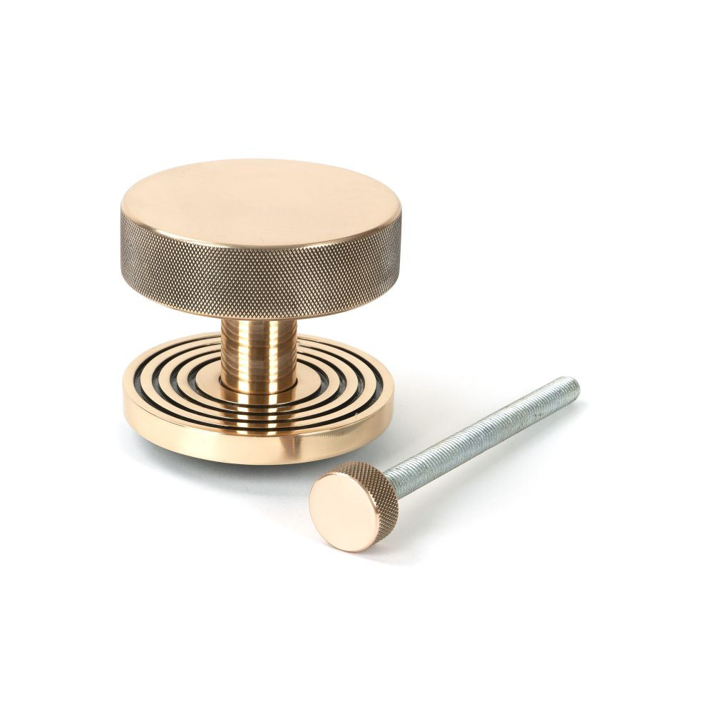 This is an image showing From The Anvil - Polished Bronze Brompton Centre Door Knob (Beehive) available from trade door handles, quick delivery and discounted prices