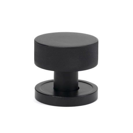 This is an image showing From The Anvil - Matt Black Brompton Mortice/Rim Knob Set (Plain) available from trade door handles, quick delivery and discounted prices