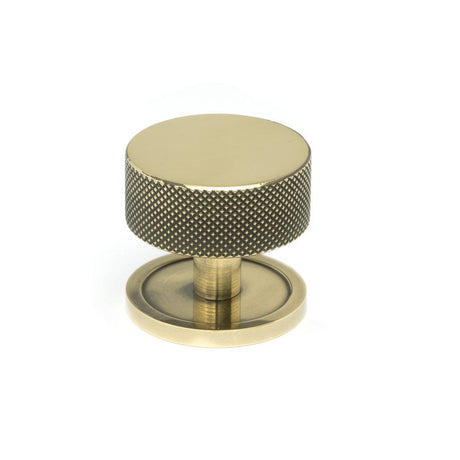 This is an image showing From The Anvil - Aged Brass Brompton Cabinet Knob - 38mm (Plain) available from T.H Wiggans Architectural Ironmongery in Kendal, quick delivery and discounted prices
