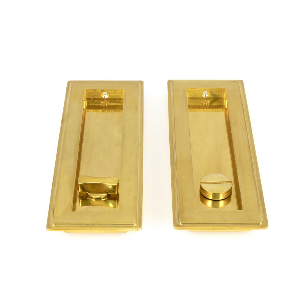 This is an image showing From The Anvil - Polished Brass 175mm Art Deco Rectangular Pull - Privacy Set available from trade door handles, quick delivery and discounted prices