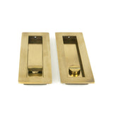 This is an image showing From The Anvil - Aged Brass 175mm Plain Rectangular Pull - Privacy Set available from trade door handles, quick delivery and discounted prices