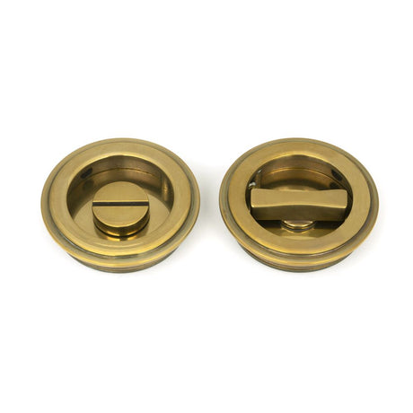 This is an image of From The Anvil - Aged Brass 60mm Art Deco Round Pull - Privacy Set available to order from T.H Wiggans Architectural Ironmongery in Kendal, quick delivery and discounted prices.