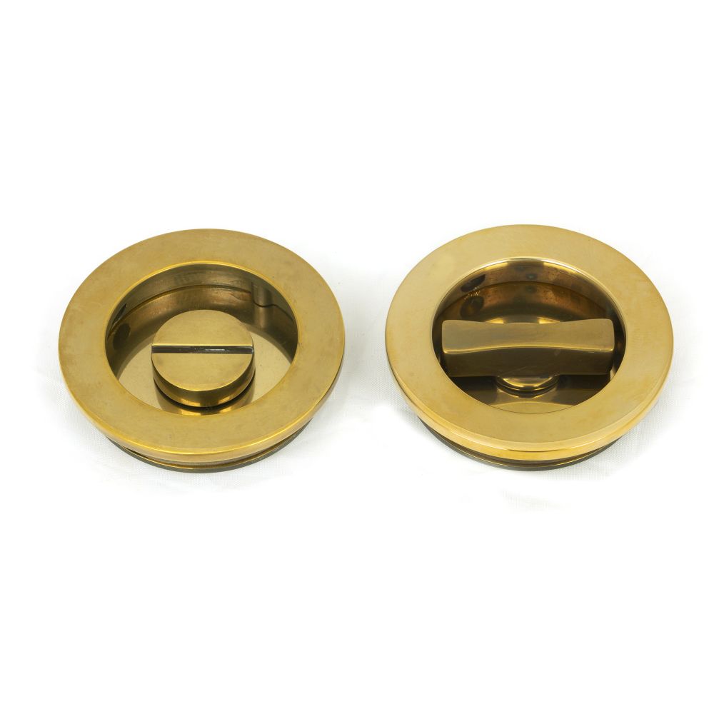 This is an image of From The Anvil - Aged Brass 60mm Plain Round Pull - Privacy Set available to order from T.H Wiggans Architectural Ironmongery in Kendal, quick delivery and discounted prices.