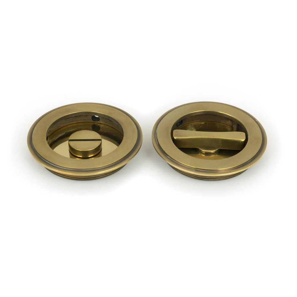 This is an image of From The Anvil - Aged Brass 75mm Plain Round Pull - Privacy Set available to order from T.H Wiggans Architectural Ironmongery in Kendal, quick delivery and discounted prices.