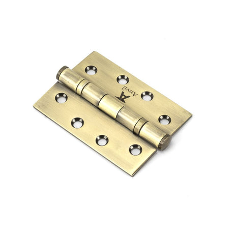 This is an image showing From The Anvil - Aged Brass 4" Ball Bearing Butt Hinge (pair) ss available from T.H Wiggans Architectural Ironmongery in Kendal, quick delivery and discounted prices