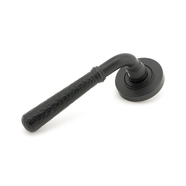 This is an image of From The Anvil - Matt Black Hammered Newbury Lever on Rose Set (Plain) - Unsprun available to order from T.H Wiggans Architectural Ironmongery in Kendal, quick delivery and discounted prices.