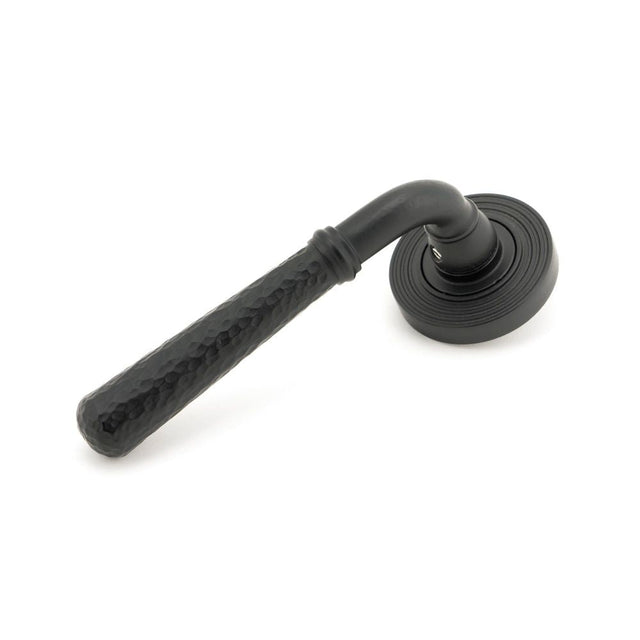 This is an image of From The Anvil - Matt Black Hammered Newbury Lever on Rose Set (Beehive) - Unspr available to order from T.H Wiggans Architectural Ironmongery in Kendal, quick delivery and discounted prices.