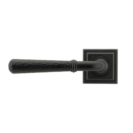 This is an image showing From The Anvil - Matt Black Hammered Newbury Lever on Rose Set (Square) - Unspru available from trade door handles, quick delivery and discounted prices