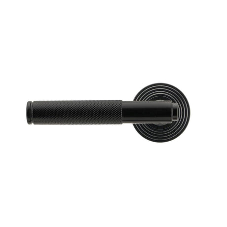 This is an image showing From The Anvil - Black Brompton Lever on Rose Set (Beehive) - Unsprung available from trade door handles, quick delivery and discounted prices