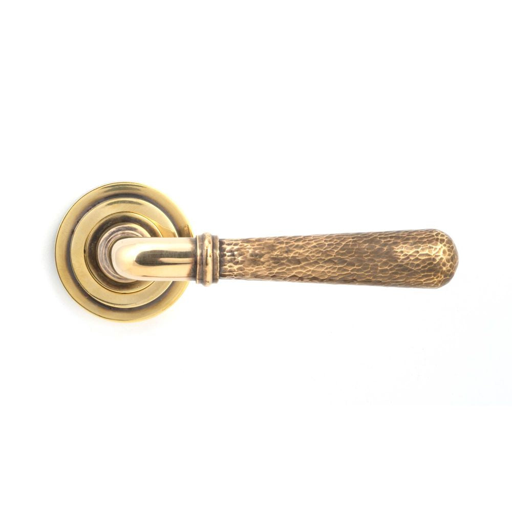 This is an image showing From The Anvil - Aged Brass Hammered Newbury Lever on Rose Set (Art Deco) - Unsp available from trade door handles, quick delivery and discounted prices