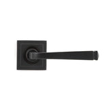 This is an image showing From The Anvil - Aged Bronze Avon Round Lever on Rose Set (Square) - Unsprung available from trade door handles, quick delivery and discounted prices